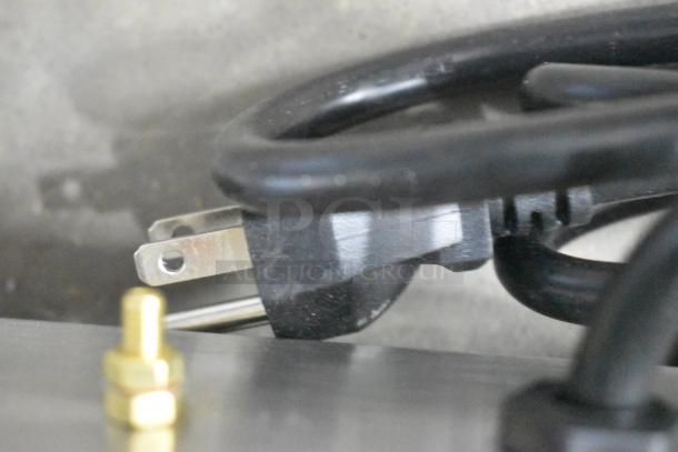 Close-up of a power plug for the 2024 Globe CM12 Stainless Steel Meat Chopper, brand new condition, 120 volts.