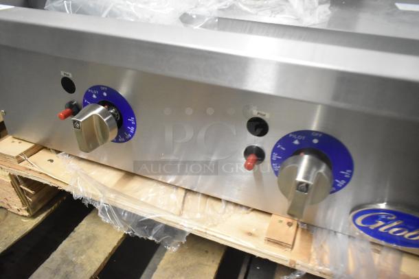 Brand new Globe GG48TG stainless steel 48" natural gas griddle, 120,000 BTU, thermostatic controls, marked pilot indicators.