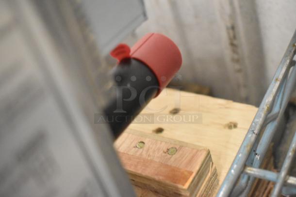 Blurred close-up image with a red cap and metal components; unclear depiction of the listed Globe GG48TG Griddle.