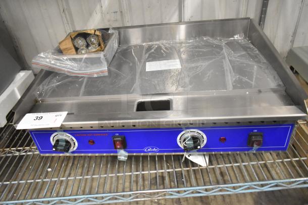 BRAND NEW Globe PG24E stainless steel commercial electric griddle, flat top, 208/240V, 1 phase, protective wrap on surface.