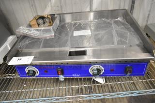 BRAND NEW Globe PG24E stainless steel commercial electric griddle, flat top, 208/240V, 1 phase, protective wrap on surface.