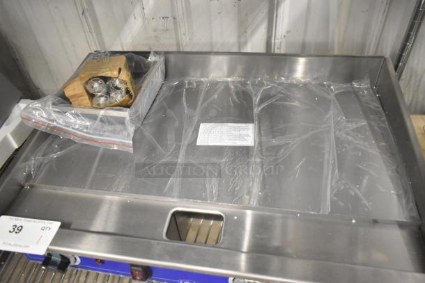 Brand new Globe PG24E stainless steel electric griddle, 208/240V, commercial countertop model, with protective plastic.