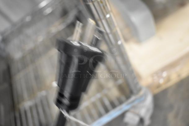 Blurry image of an electric plug for a Globe PG24E stainless steel griddle. Details of the item are not visible.