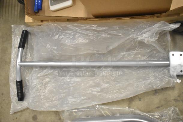 Brand new metal commercial mixing bowl dolly with durable handle, resting on protective plastic wrap.