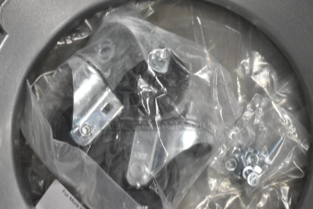 Brand new metal commercial mixing bowl dolly with wheels and hardware, still in packaging.