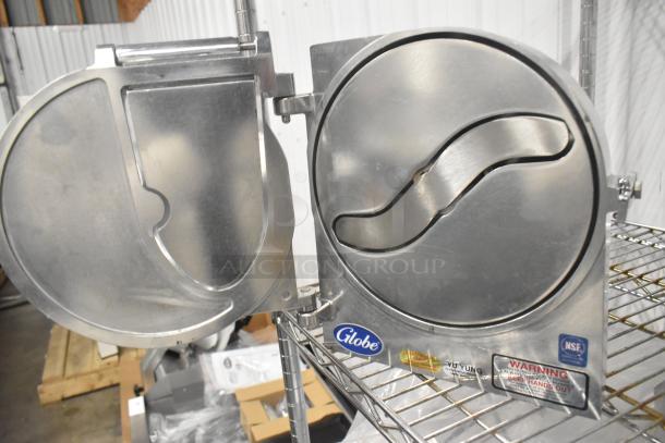 Brand new Globe metal commercial pelican head with slicing blade, NSF certified, various safety warnings displayed.