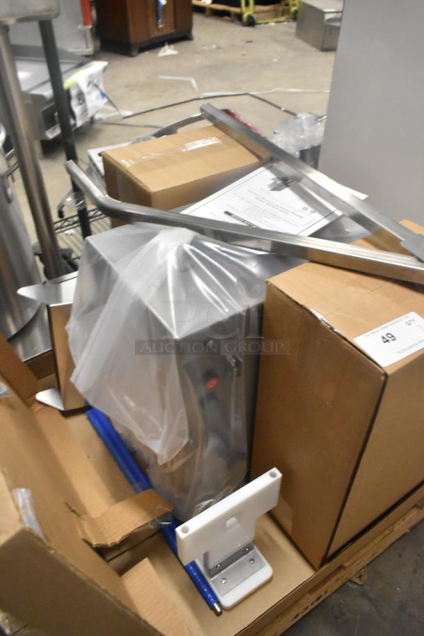 Brand new Globe GSCS2 electric cheese shredder, 65 lb/min capacity, enclosed in packaging with assembly parts and manual.