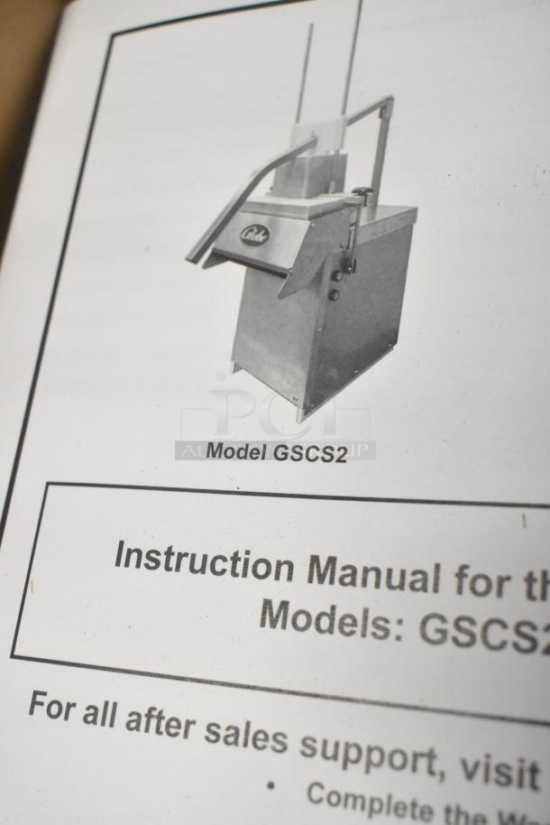 Brand new Globe GSCS2 metal commercial countertop cheese shredder, 65 lb/min capacity, with instruction manual shown.