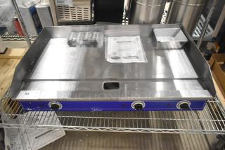 Brand new Globe GEG36 electric griddle, stainless steel, 208/240 volts, with controls and documentation on a countertop.
