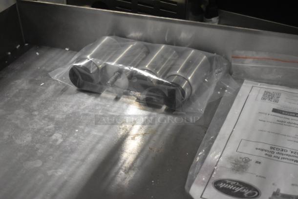 Brand new Globe GEG36 stainless steel electric griddle, 208/240 volts, 1 phase. Includes manual and accessories, pristine condition.