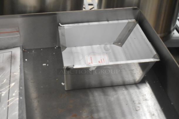 Brand new Globe GEG36 stainless steel electric griddle, flat top, 208/240V, 1 phase, visible labels.