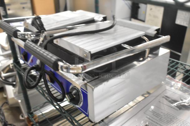 BRAND NEW 2024 Globe GSGDUE10 stainless steel double panini press, 240V, 1 phase, with grip handles and control knobs.