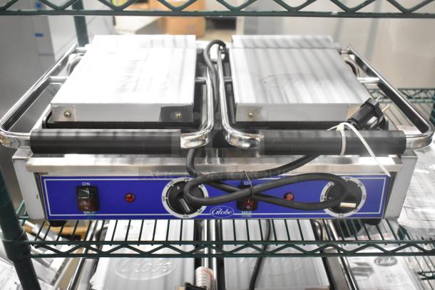Brand new 2024 Globe GSGDUE10 stainless steel commercial countertop double panini press, 240V, 1 phase, with controls.