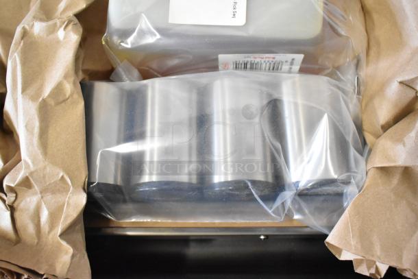 Brand new Globe GVP20 stainless steel commercial vacuum sealer with 16.5" seal bar, in original packaging.