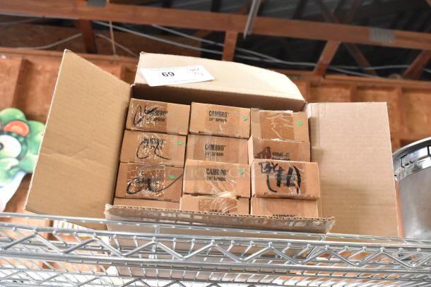 Boxes of 12 Cambro SPO10CW110 black buffet spoons, scratch and dent, stacked in an open cardboard box.