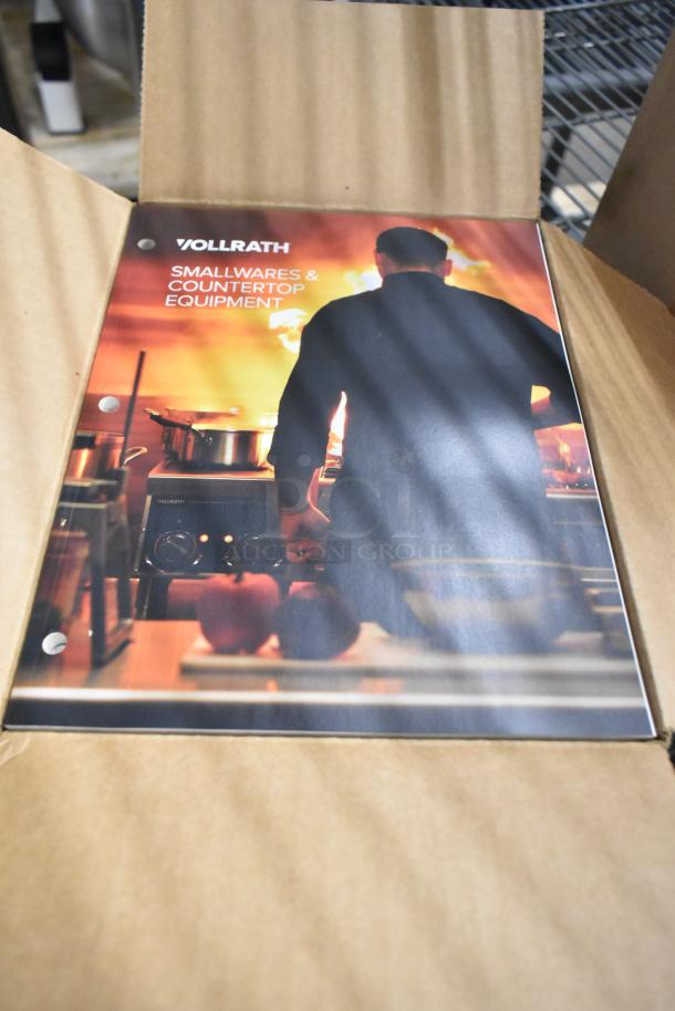Three brand new boxes of Vollrath booklets featuring smallwares and countertop equipment, unopened and in pristine condition.