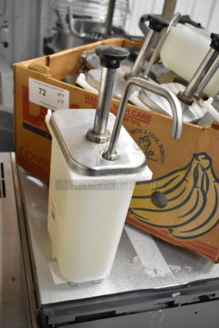 9 white poly bins with stainless steel pump lids, shown in a cardboard box. Each bin features a manual pump system.