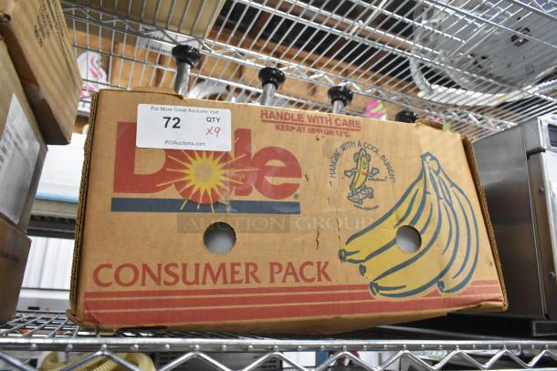 9 white poly bins with stainless steel pump lids on shelf; marked "Qty 9" with auction tag; cardboard box labeled "Dole Consumer Pack."
