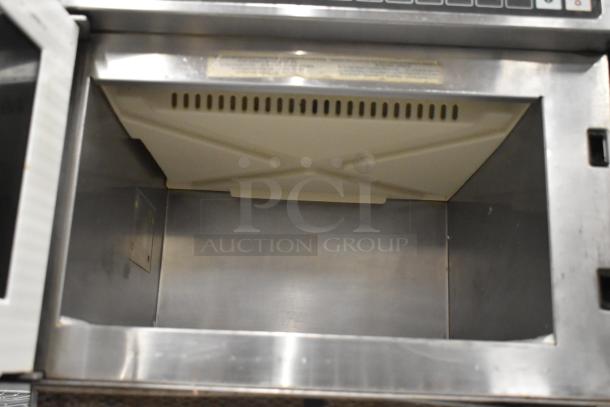 Amana HDC10 stainless steel commercial countertop microwave oven, 120 volts, 1 phase. Interior view, clean, durable build.