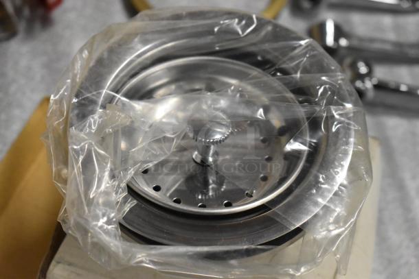 Lot of various items including handles and a rack, packaged in plastic. Appears unused with visible metal components.