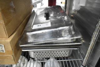 Five metal kitchen items including a perforated steam pan and chafer lids, visible auction label reads "83, QTY x5".