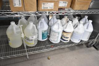20 jugs of cleaners, including Broad-cide 128 and Neutral Clean Floor Cleanser, placed on a metal shelf.