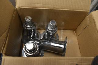 Set of 4 brand new metal legs in a box, shiny chrome finish, sturdy construction, ideal for furniture assembly.