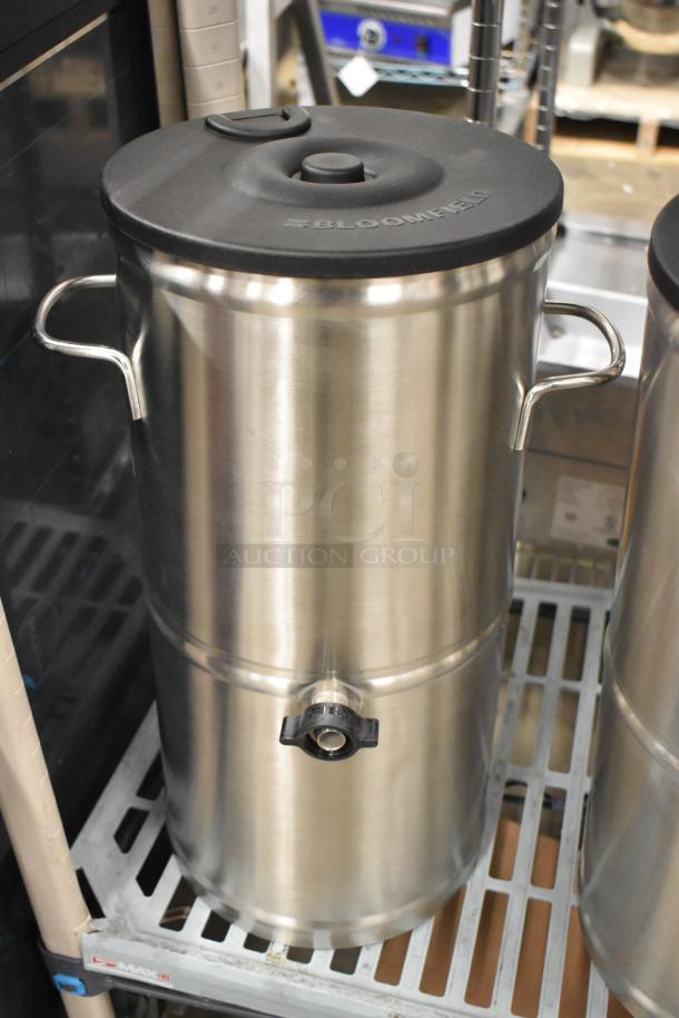 Brand new Bloomfield 8799 stainless steel iced tea dispenser with handles and spout, black lid with Bloomfield logo.