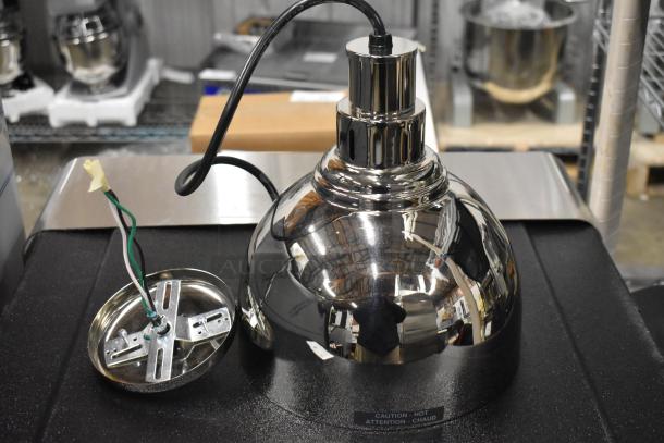 Brand new Hatco DL-725-CN metal heat lamp, 120 volts, 1 phase. Features a reflective chrome finish and caution label.