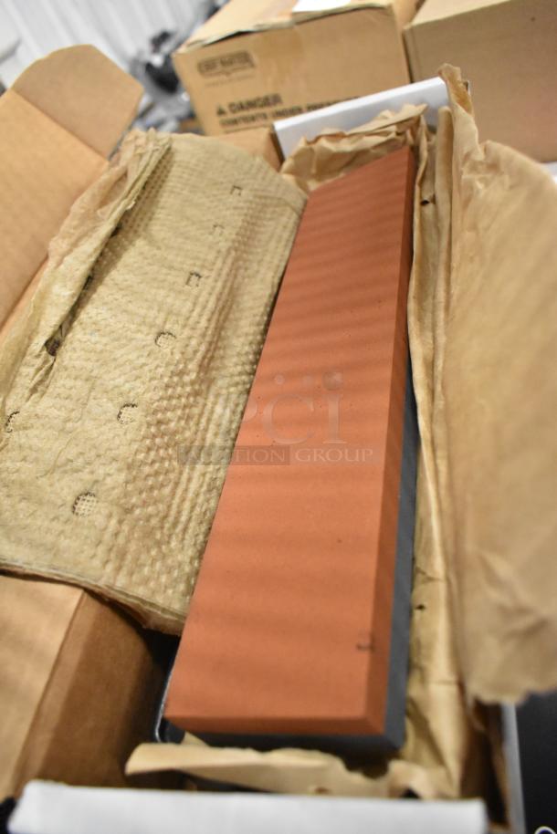 New red bricks in packaging, showing a smooth finish. Unused condition, packed in cardboard and protective wrapping.