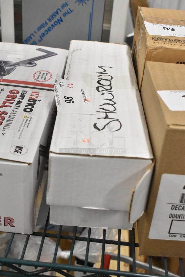 Boxes labeled "Showroom" on a shelf with adjacent boxes. Auction label "#98" visible. Condition appears unopened.