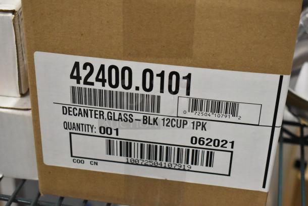 Brand new coffee pots, model 42400-0101, 12-cup glass decanter, black, 3 units. Boxed, mint condition. Quantity: 001.