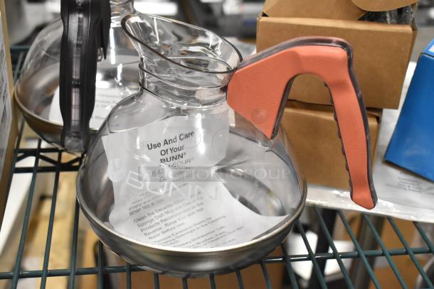 Three brand new BUNN glass coffee pots, model 42400-0101, with instructions; clear glass, red handle, mint condition.
