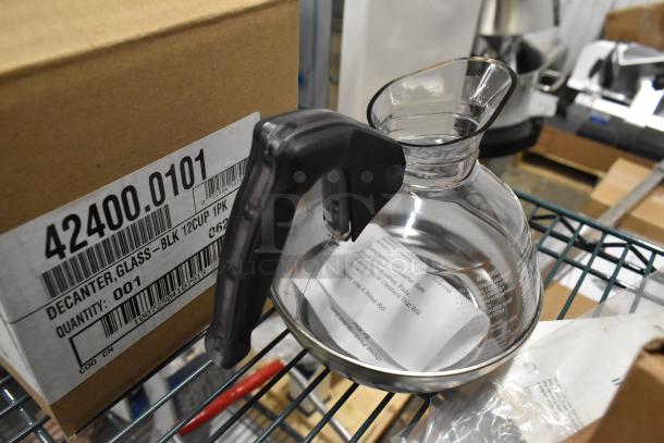 Three brand new glass coffee pots, model 42400-0101, each with black handle and 12-cup capacity, in original packaging.