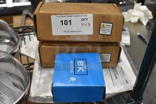 Three new items, including BK BKD-8-G deck mount faucet, in original packaging with warning labels visible.