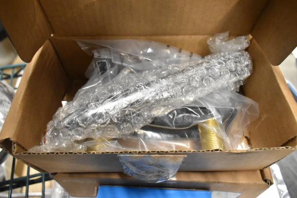 Box containing three brand new items, including a BK BKD-8-G deck mount faucet, wrapped in bubble wrap and protective packaging.