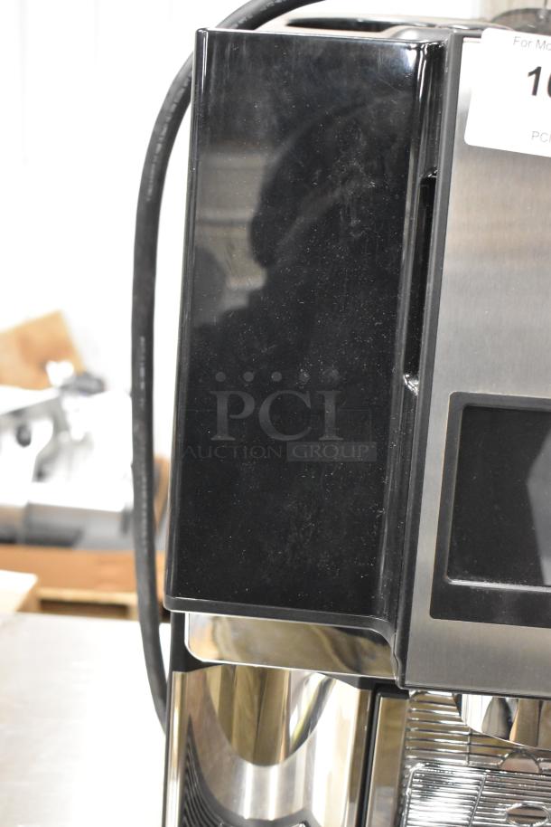 Brand new stainless steel commercial espresso machine, automatic, with hot water dispenser. Black casing, 120/208-240V, 1 Phase.