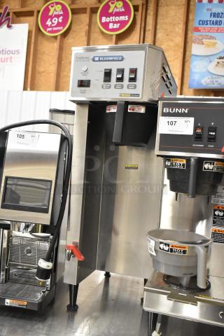 Bloomfield 8795 stainless steel iced tea machine with hot water dispenser, 120/240V, brand new condition, labeled controls.