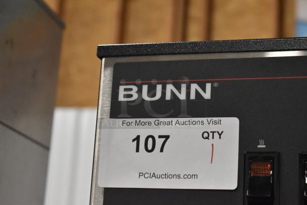 BRAND NEW 2018 Bunn DUAL stainless steel coffee machine, dual brewer, hot water dispenser, model DUAL. Auction tag displayed.