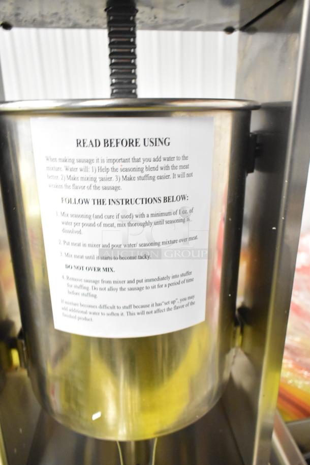 Brand new Avantco SS-20V 20 lb. stainless steel vertical sausage stuffer with instructions on cylinder. Includes four funnels.