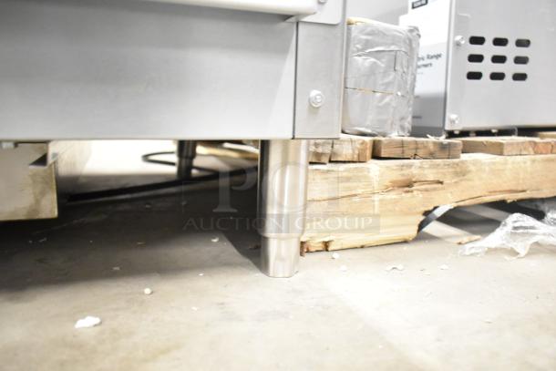 Brand new Vollrath 922GGMDM24 stainless steel 24" countertop griddle, 56,000 BTU, visible on shipping pallet.