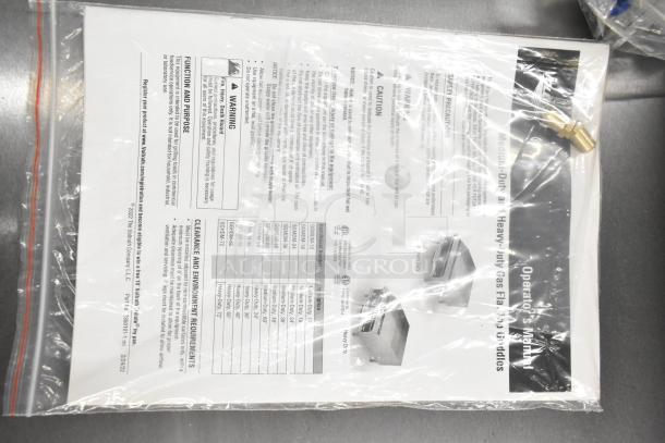 Alt text: Operator's manual for Vollrath 922GGMDM24 countertop griddle, sealed in packaging, includes installation instructions.