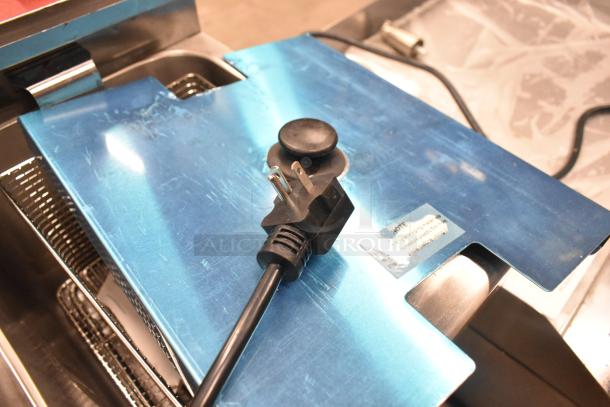 Brand new Avantco F202 30 lb. dual tank electric fryer with metal lids and fry baskets; scratch and dent condition.