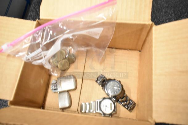 4-item auction lot: 2 metal watches, 1 silver metal lighter, and a bag of assorted coins in a box.