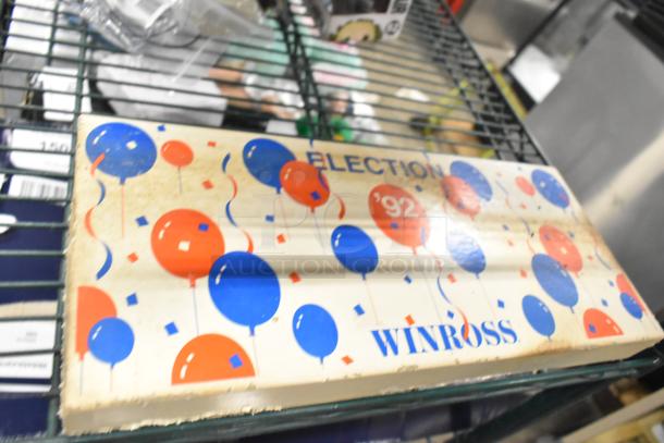 Tier lot of items including HP Southbend Igniter and Flame Sensor, jeans, and Pez dispenser on metal shelf.