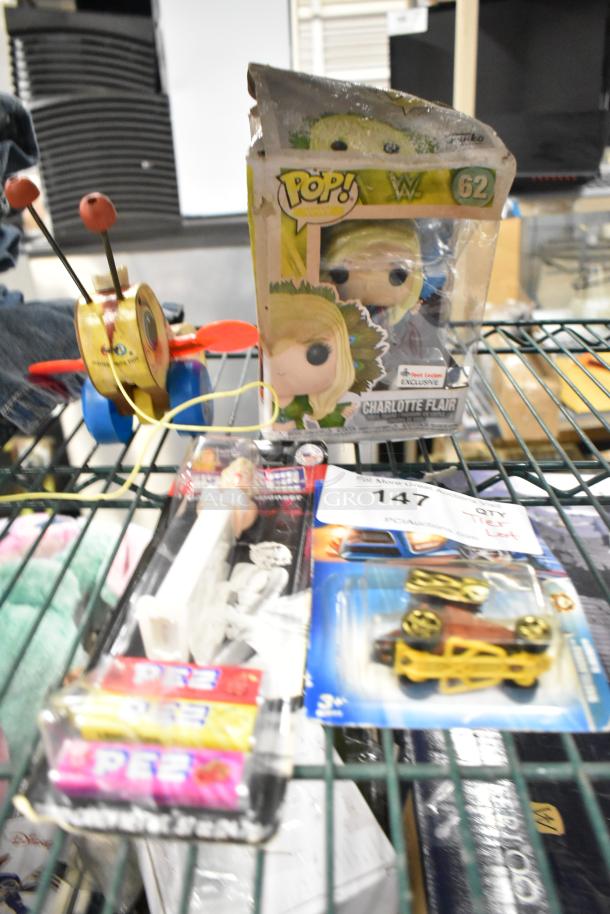 Tier lot with items: Southbend 1195748 igniter, 1195448 flame sensor, Pez dispenser, Pop! figure, toy car. Mixed condition.