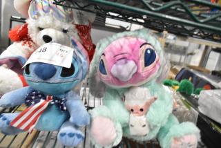 Assorted 6 stuffed animals including a white bear, Stitch, and Angel in a green costume. Features auction tag "148 QTY 6."