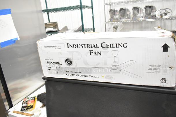 Brand new Canarm 48" white ceiling fan, model CP48D11N. Scratch and dent condition, 7370 CFM, 120V, 1 phase. Box visible.