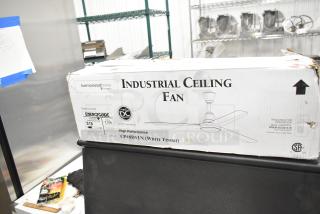 Brand new Canarm 48" white ceiling fan, model CP48D11N. Scratch and dent condition, 7370 CFM, 120V, 1 phase. Box visible.