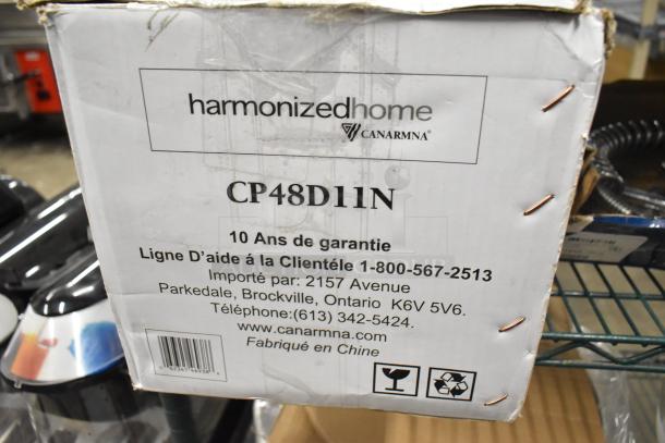 Alt text: 

Box of Canarm 48" industrial ceiling fan, model CP48D11N, 7370 CFM, 120V, scratch and dent condition, with visible warranty info.